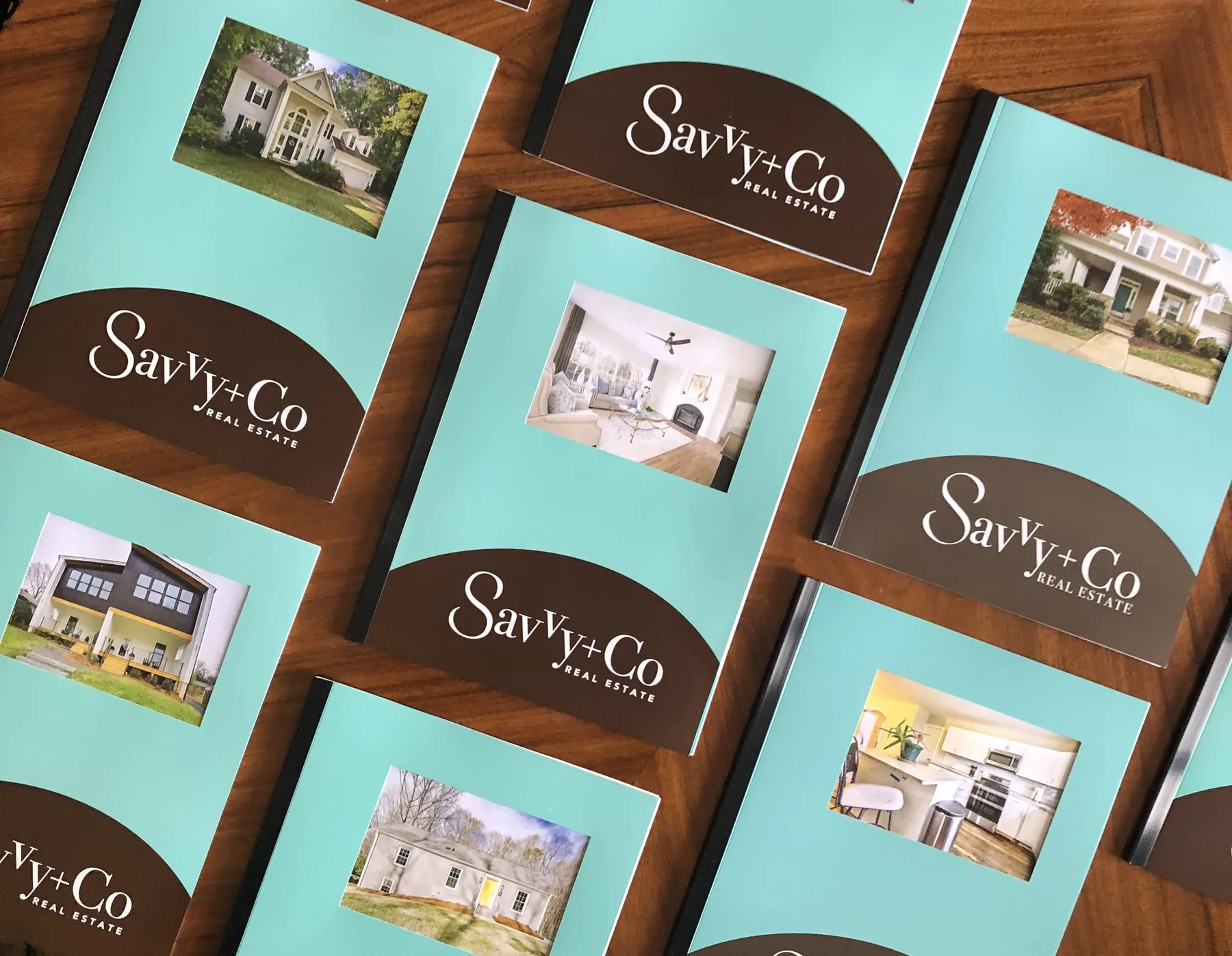 Savvy + Co. property brochures laid out on a table